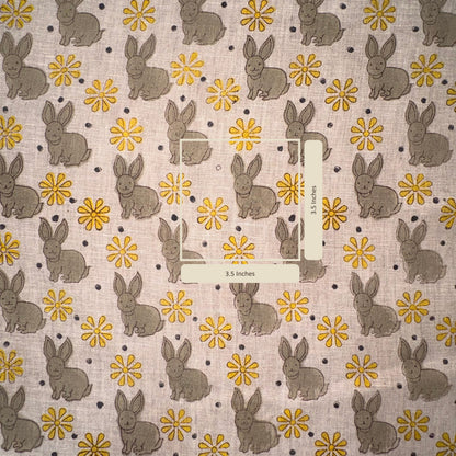 Fabric with bunny and flower pattern on a grey background