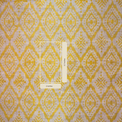 Fabric with yellow and grey diamond pattern and a ruler for scale.