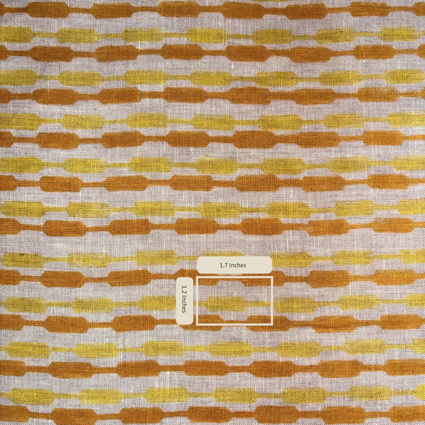 Fabric with a pattern of brown and yellow shapes on a grey background
