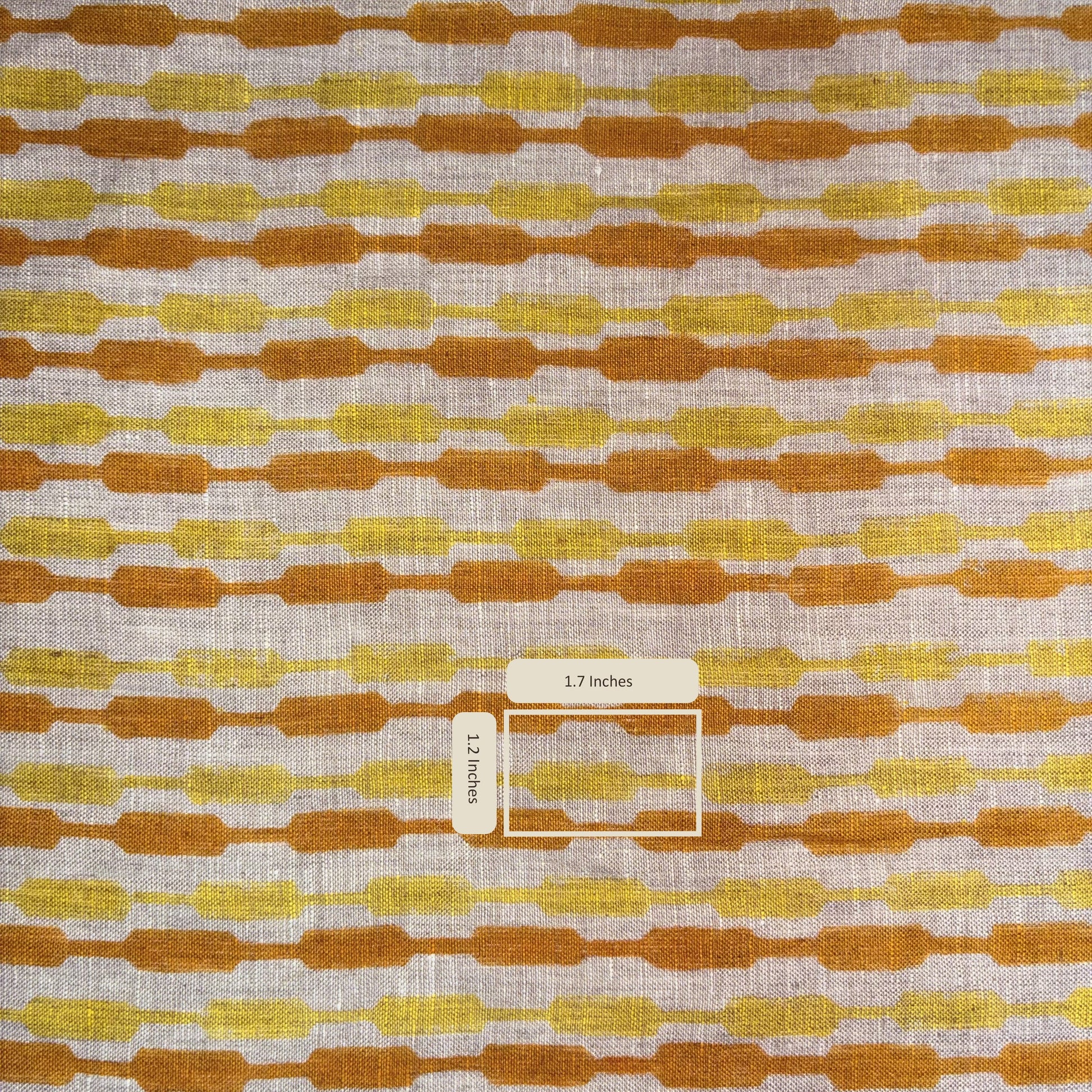 Fabric with a pattern of brown and yellow shapes on a grey background