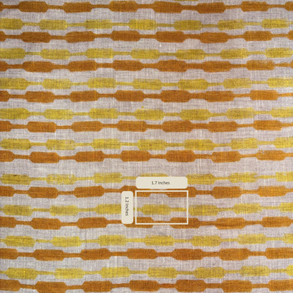Fabric with a pattern of brown and yellow shapes on a grey background
