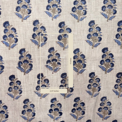 Patterned fabric with blue floral design on a grey background with measurement scale