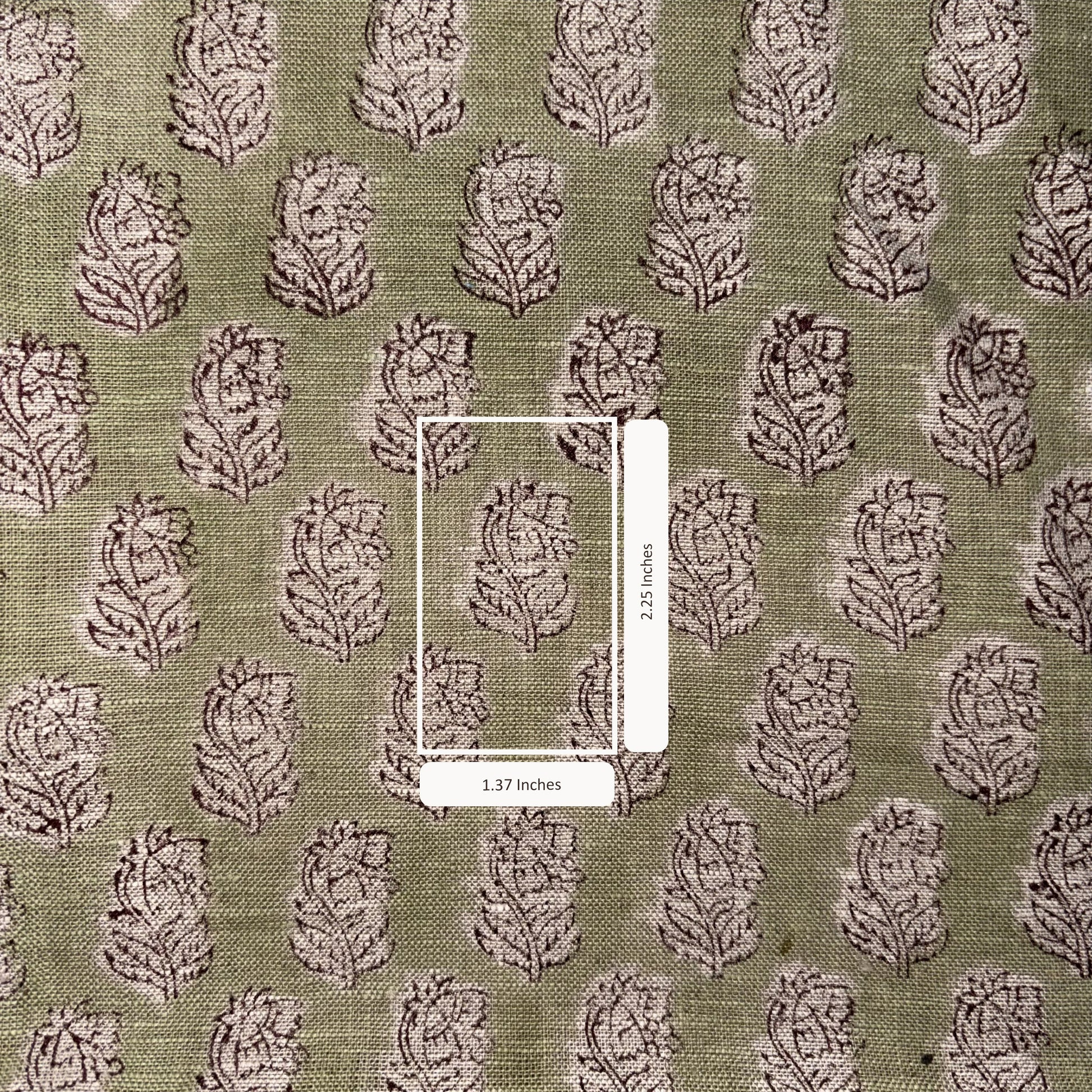 Patterned fabric with a scale bar indicating dimensions on a green background