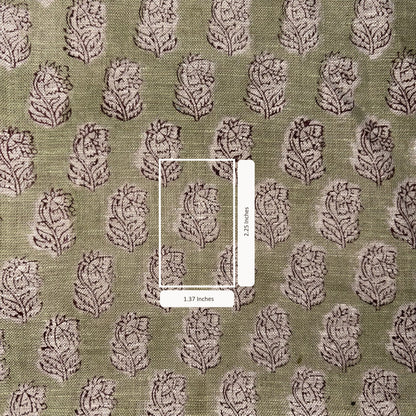 Patterned fabric with a scale bar indicating dimensions on a green background