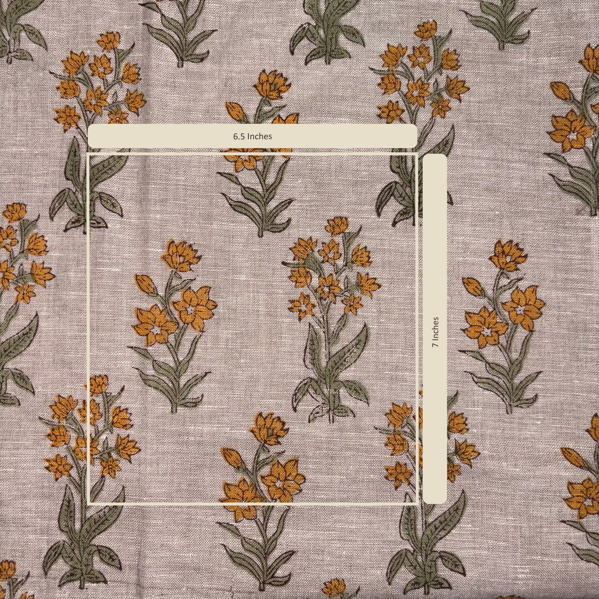 Floral patterned fabric with a ruler for scale on a matching background