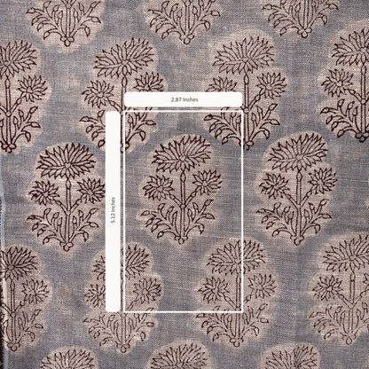 Textile with floral pattern and measurement label on a gray background