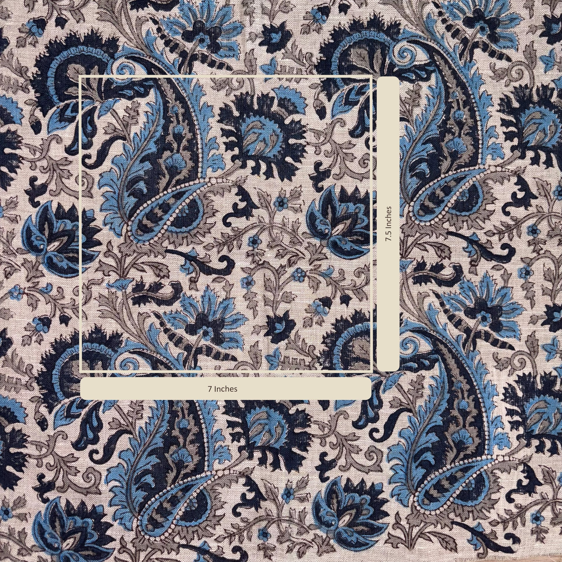 Patterned fabric with blue and black paisley design on a grey background