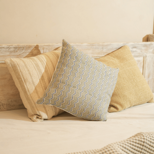 Decorative pillows on a bed with a neutral color scheme