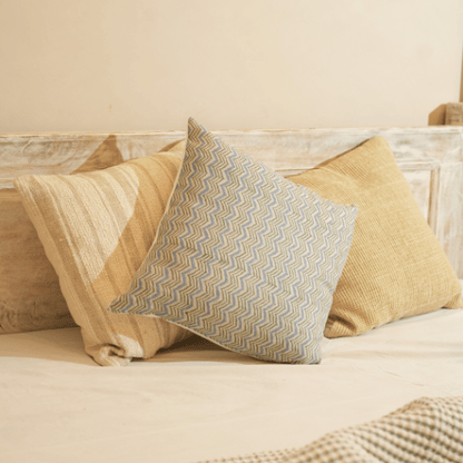Decorative pillows on a bed with a neutral color scheme