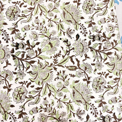 Floral patterned fabric in green and brown on a white background