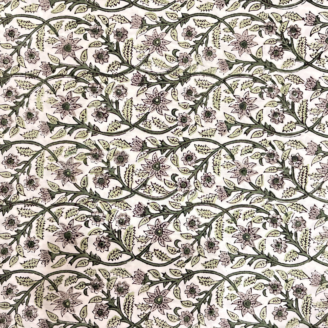 Floral patterned fabric in green on a white background