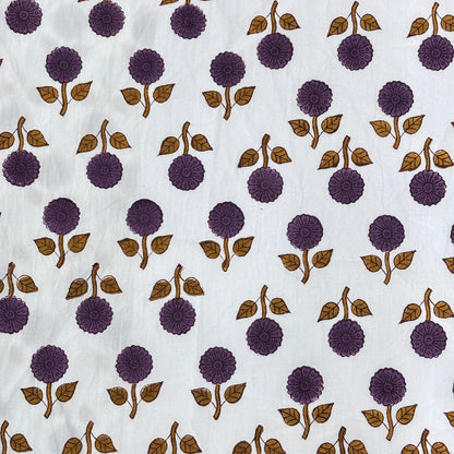 White fabric with a repeating block-print pattern of purple flowers and brown leaves.