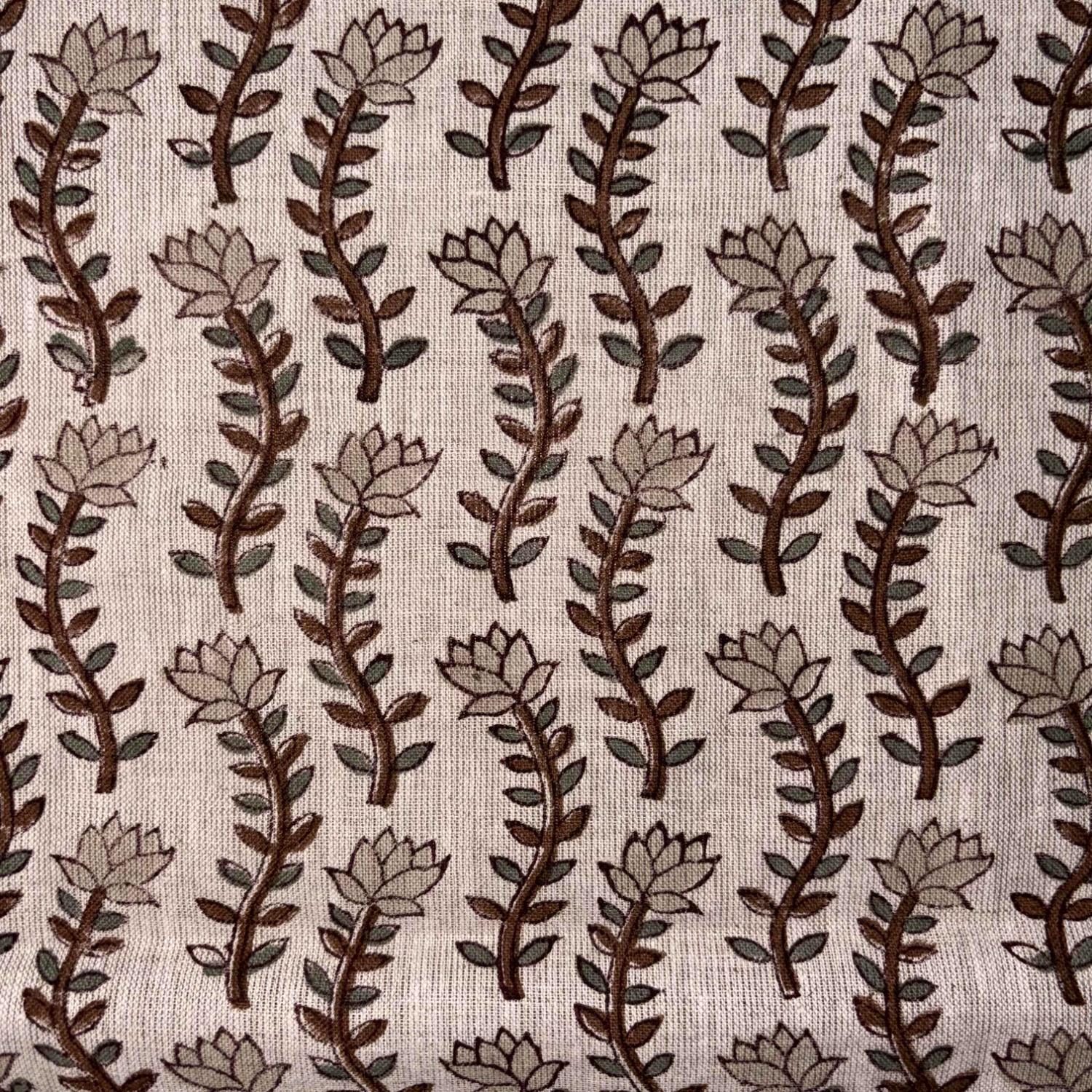 Patterned fabric with brown and beige leaves on a grey background