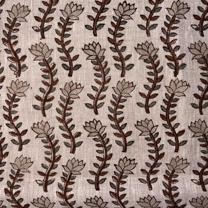 Patterned fabric with brown and beige leaves on a grey background