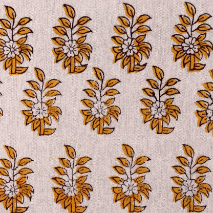 Pattern of yellow floral designs on a beige fabric background
