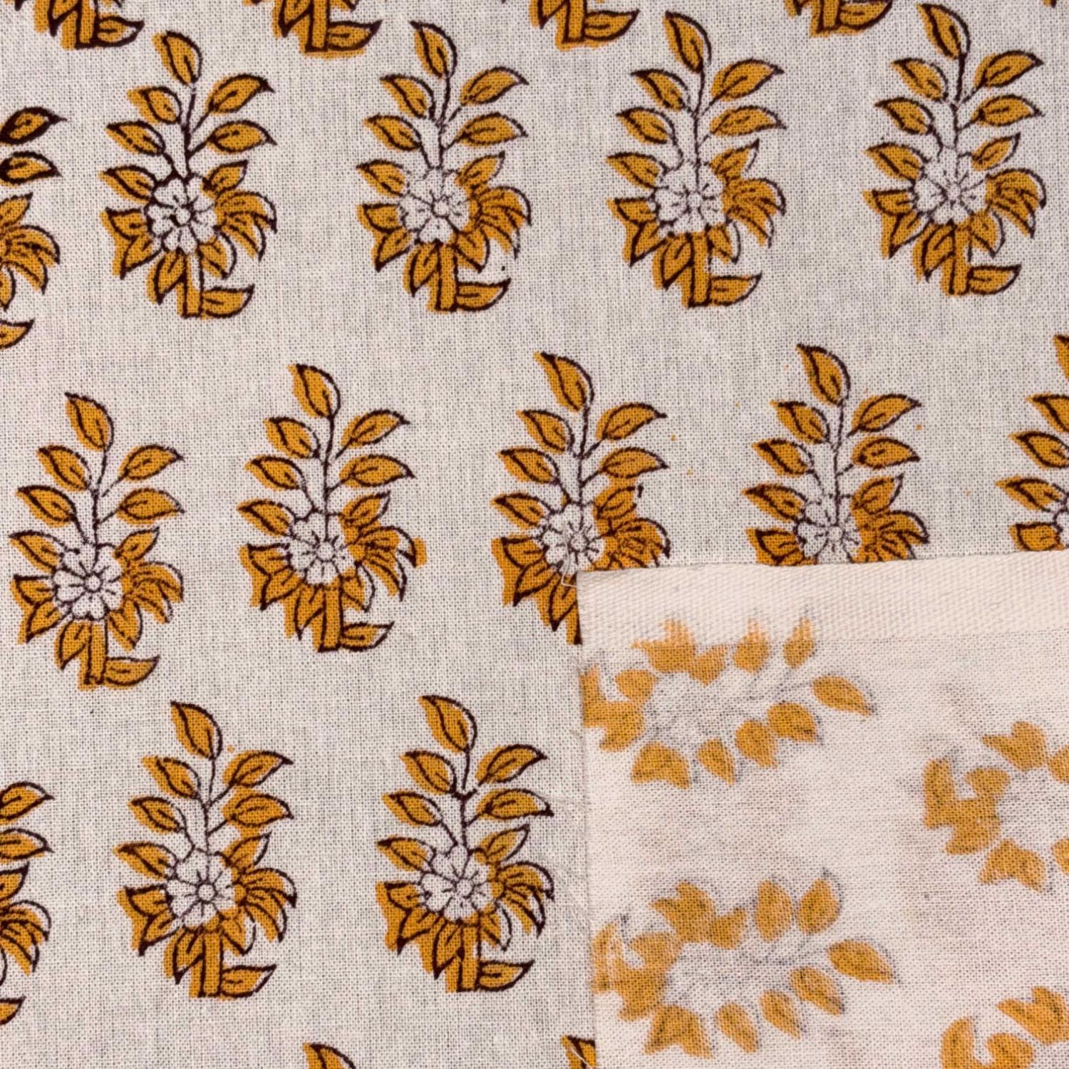 Patterned fabric with yellow floral designs on a beige background