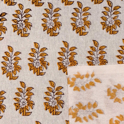 Patterned fabric with yellow floral designs on a beige background