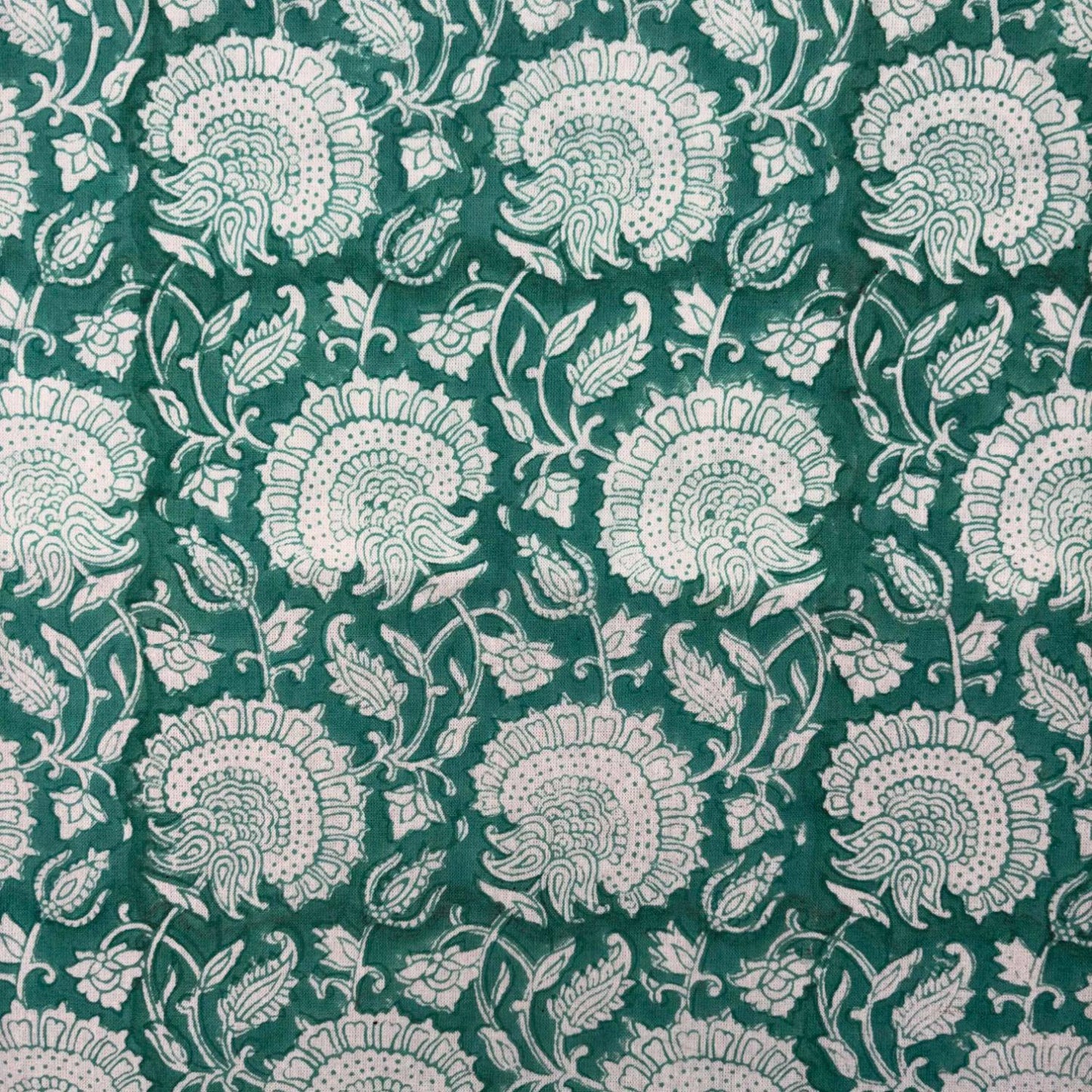 Patterned fabric with white floral design on a green background