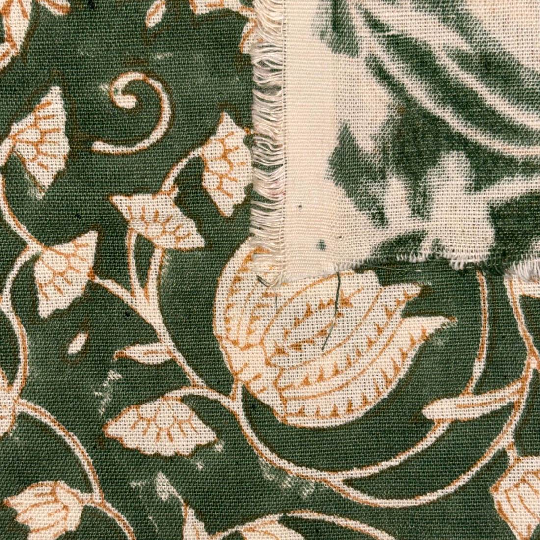 Close-up of fabric with floral pattern on green background