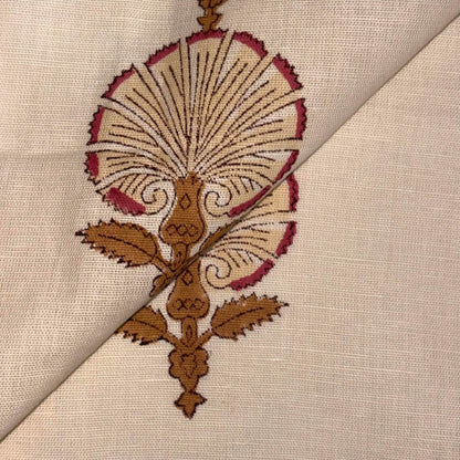 Close-up of intricate embroidery on fabric with brown and red thread