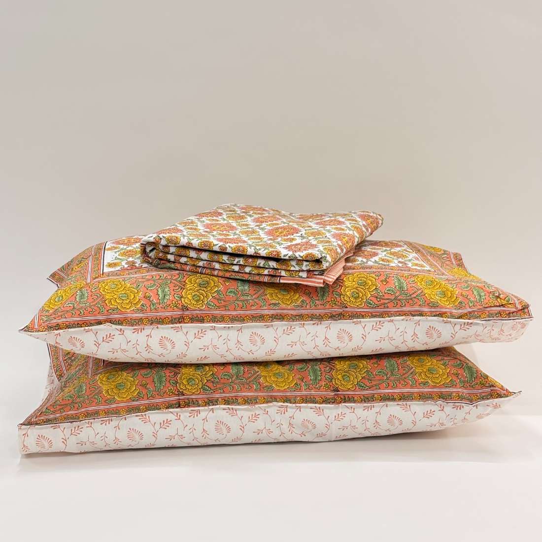Stack of patterned pillows on a light gray background