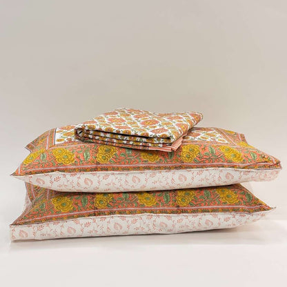 Stack of patterned pillows on a light gray background