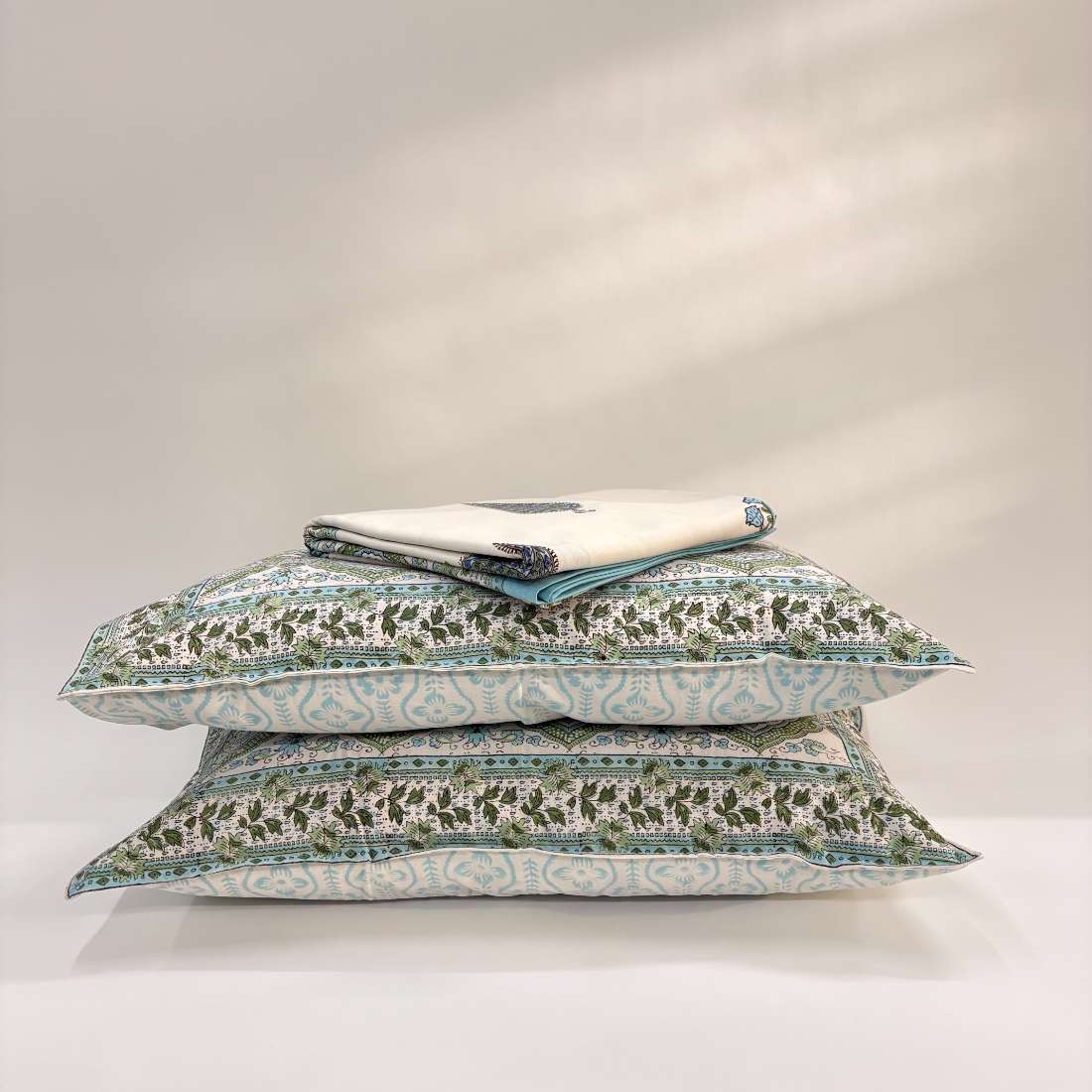 Set of decorative pillows with floral patterns on a white background
