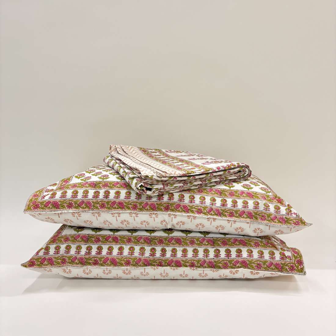 Stack of patterned pillows on a white background