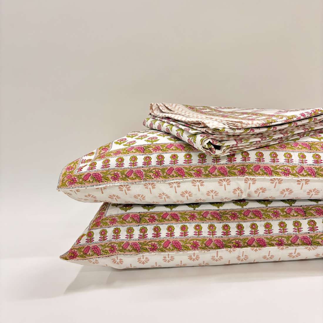 Stack of pillows on a light background.