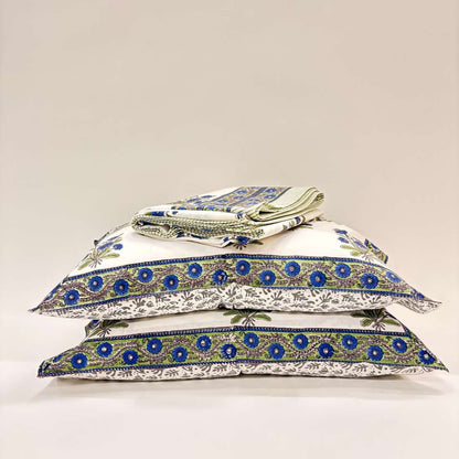 Stack of pillows with blue and green patterns on a white background