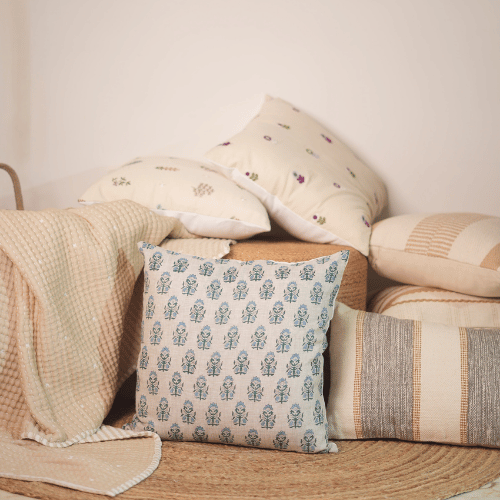 Decorative pillows with patterns on a wooden surface