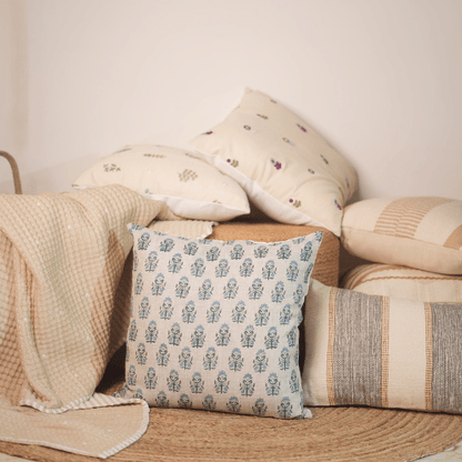 Decorative pillows with patterns on a wooden surface