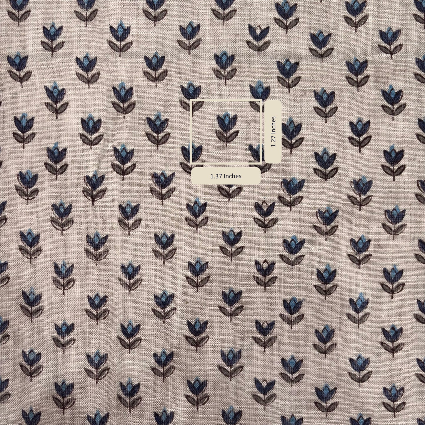 Fabric with blue floral pattern and a label on a grey background