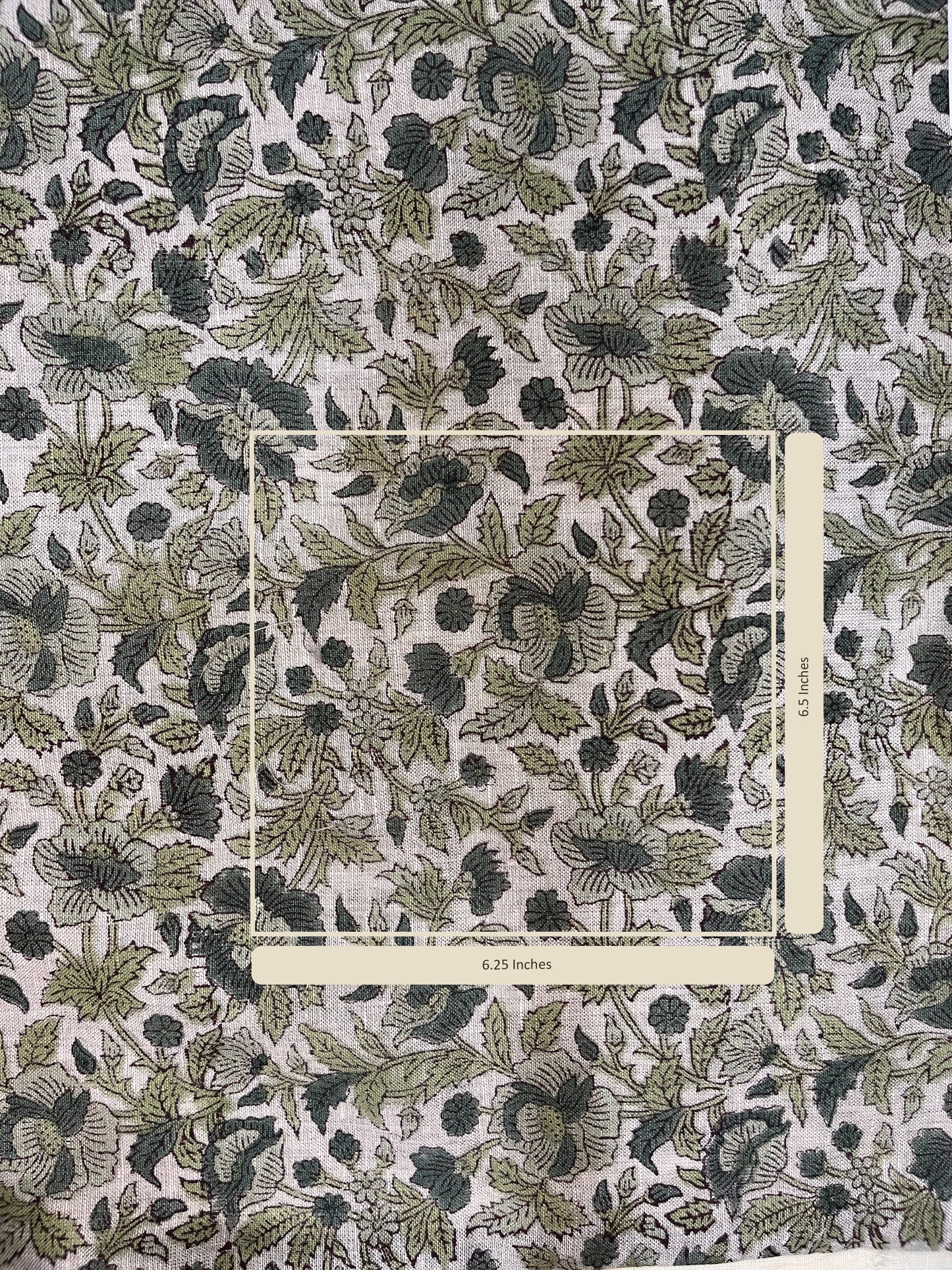 Floral patterned fabric with a ruler for scale on a grey background