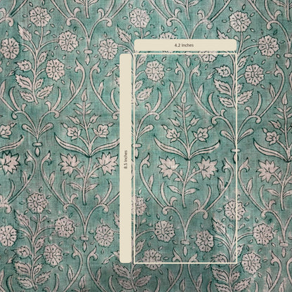 Floral patterned fabric with a ruler for scale on a teal background