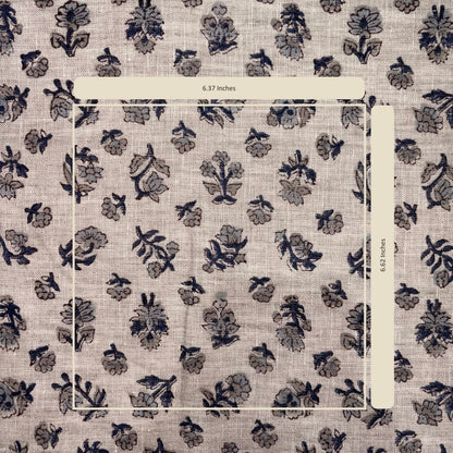 Floral patterned fabric with a ruler for scale on a beige background