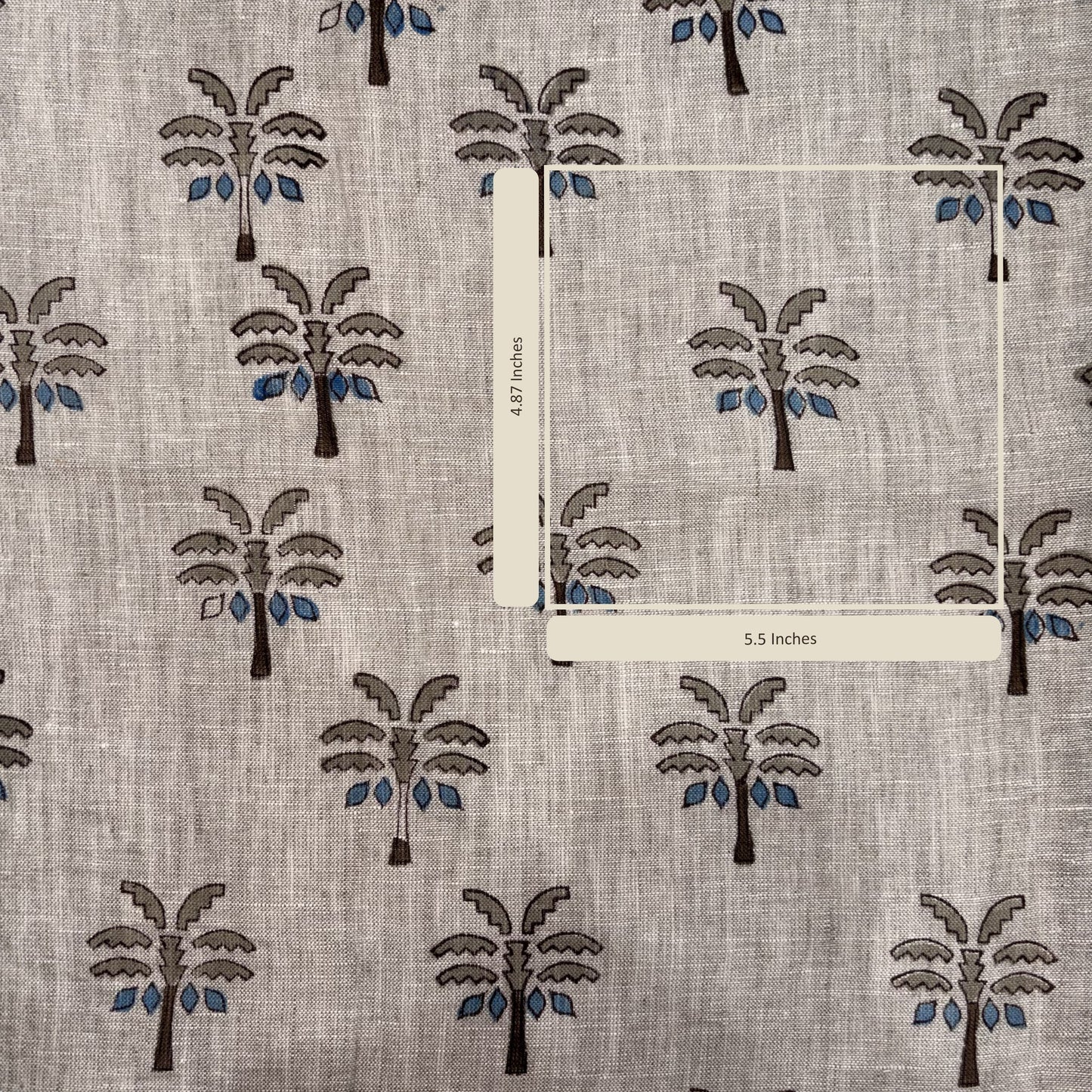 Fabric with palm tree pattern and measurement labels on a gray background