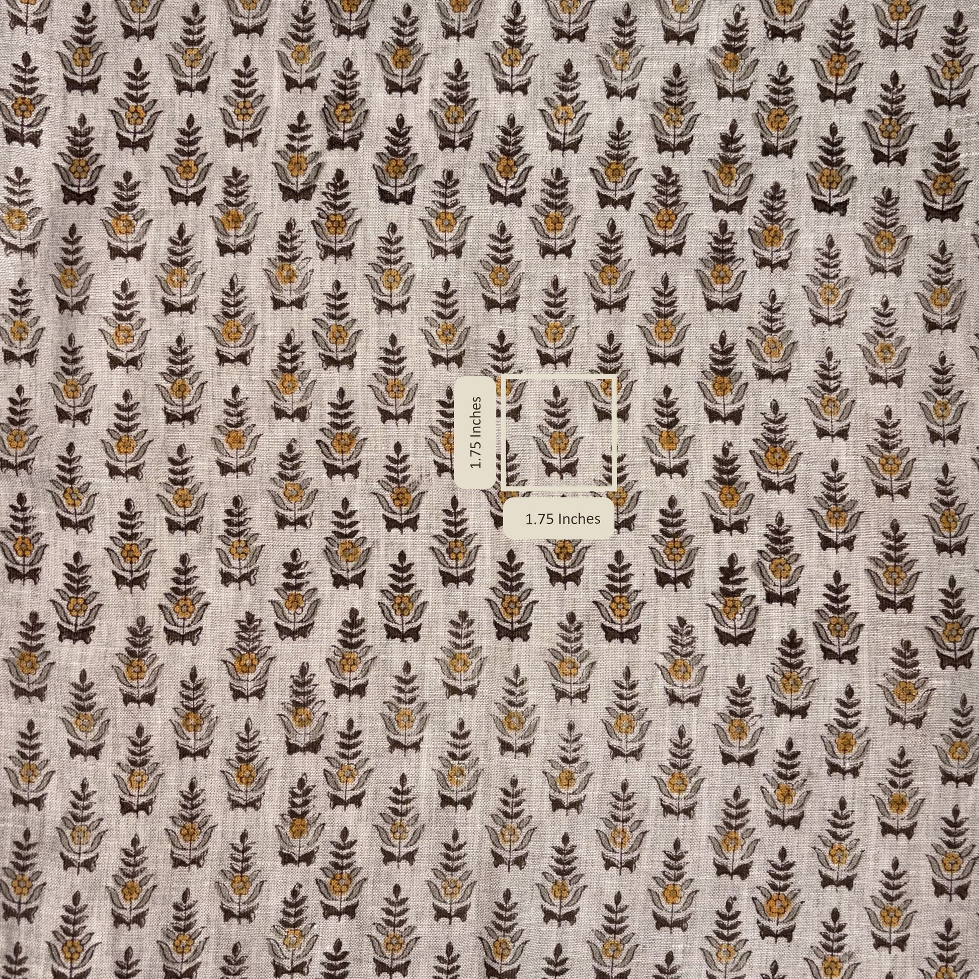 Fabric with a pattern of small leaf-like shapes on a neutral background, with a label indicating fabric dimensions.