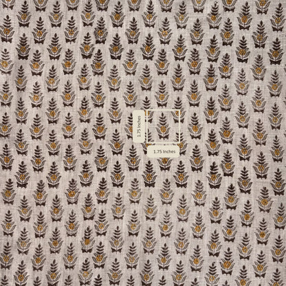 Fabric with a pattern of small leaf-like shapes on a neutral background, with a label indicating fabric dimensions.