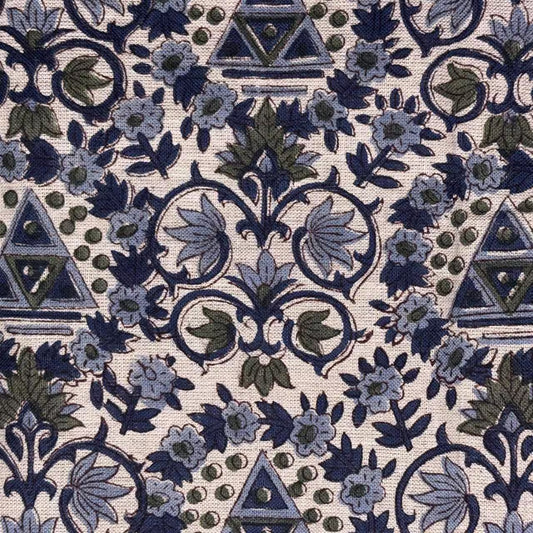 Close-up of a patterned fabric with blue and green designs on a grey background