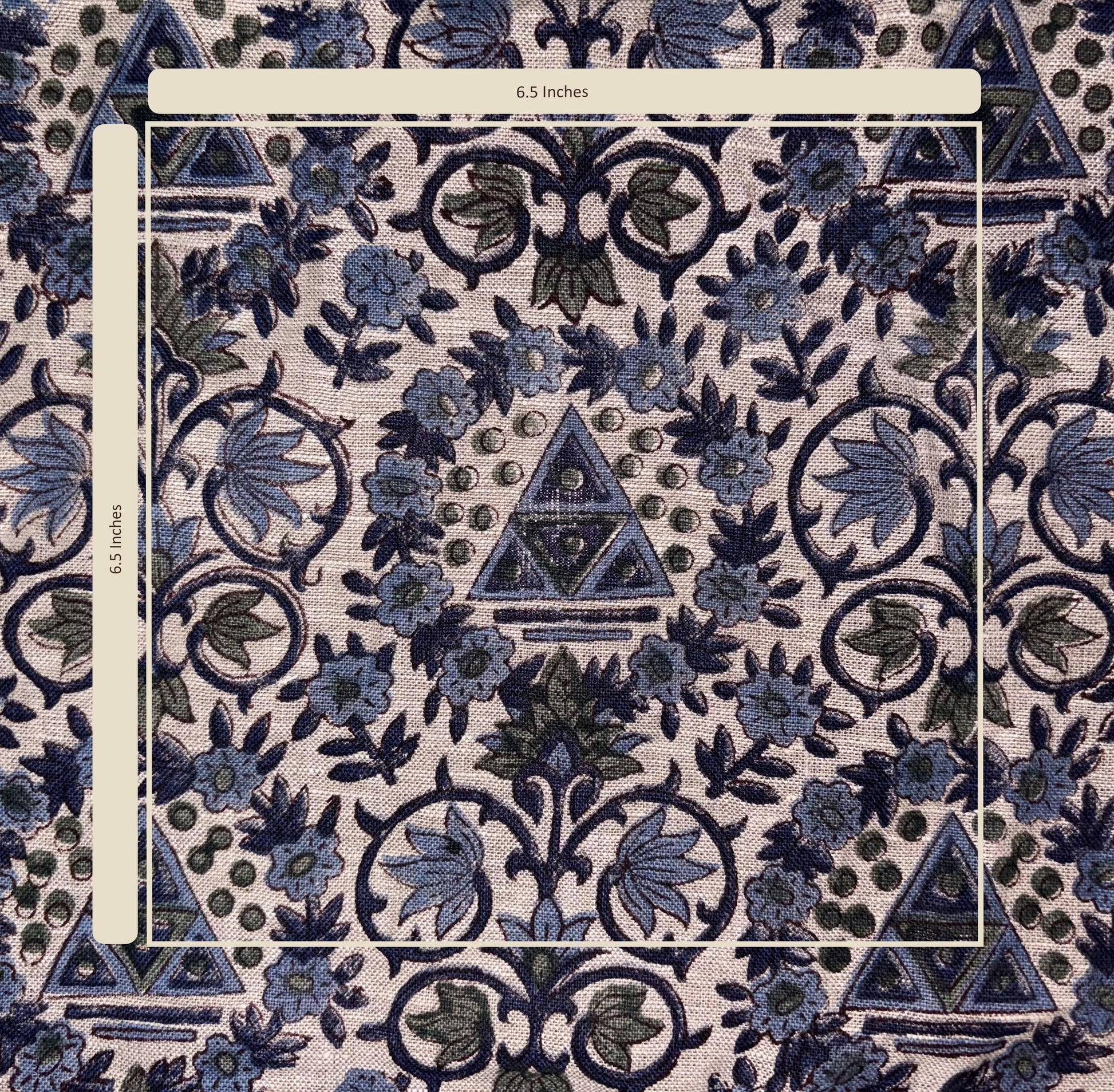 Patterned fabric with blue and green design, featuring triangles and floral elements.