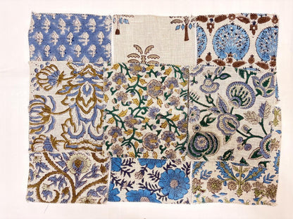 A square textile product with a patchwork of ornate floral and geometric patterns in blue, beige, brown, and white, photographed flat against a white background.